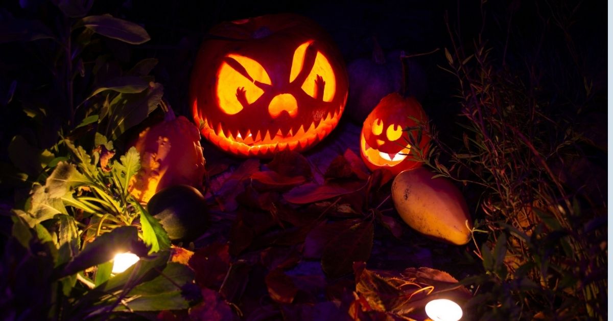 Glowing jack-o’-lanterns in a tropical garden at night, setting a spooky Halloween mood in Bali.